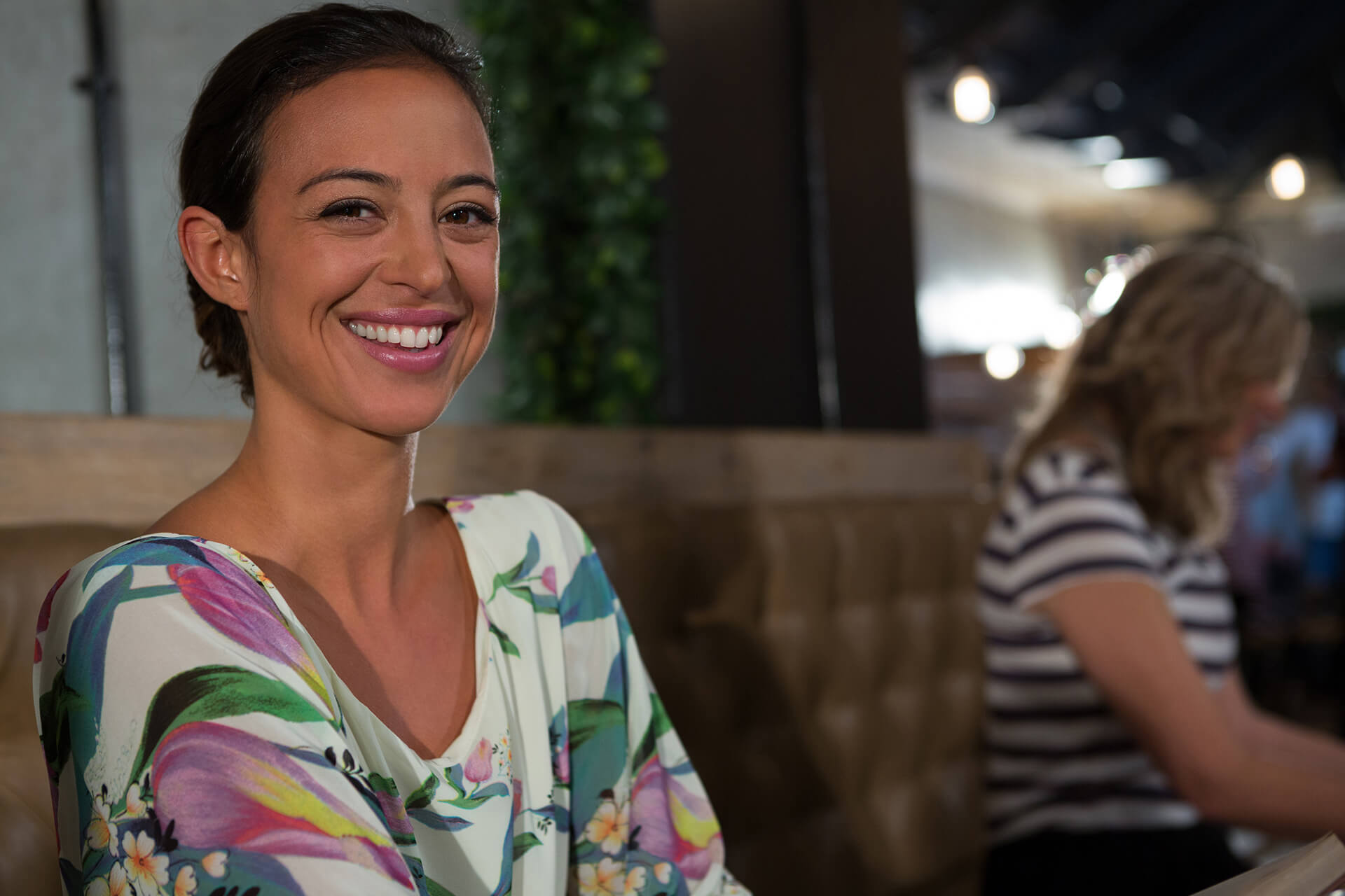 happy-woman-sitting-in-restaurant-5QUFESD.jpg